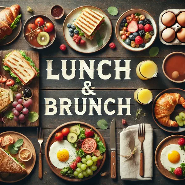 A rustic flat lay of lunch and brunch foods on a medium-dark wooden table with horizontal planks. The scene includes sandwiches, salad, croissants, pancakes, eggs, and fresh fruit, arranged minimally with warm natural lighting. At the top, the words 'LUNCH & BRUNCH' are written in large cream-colored serif letters, centered and clearly visible.